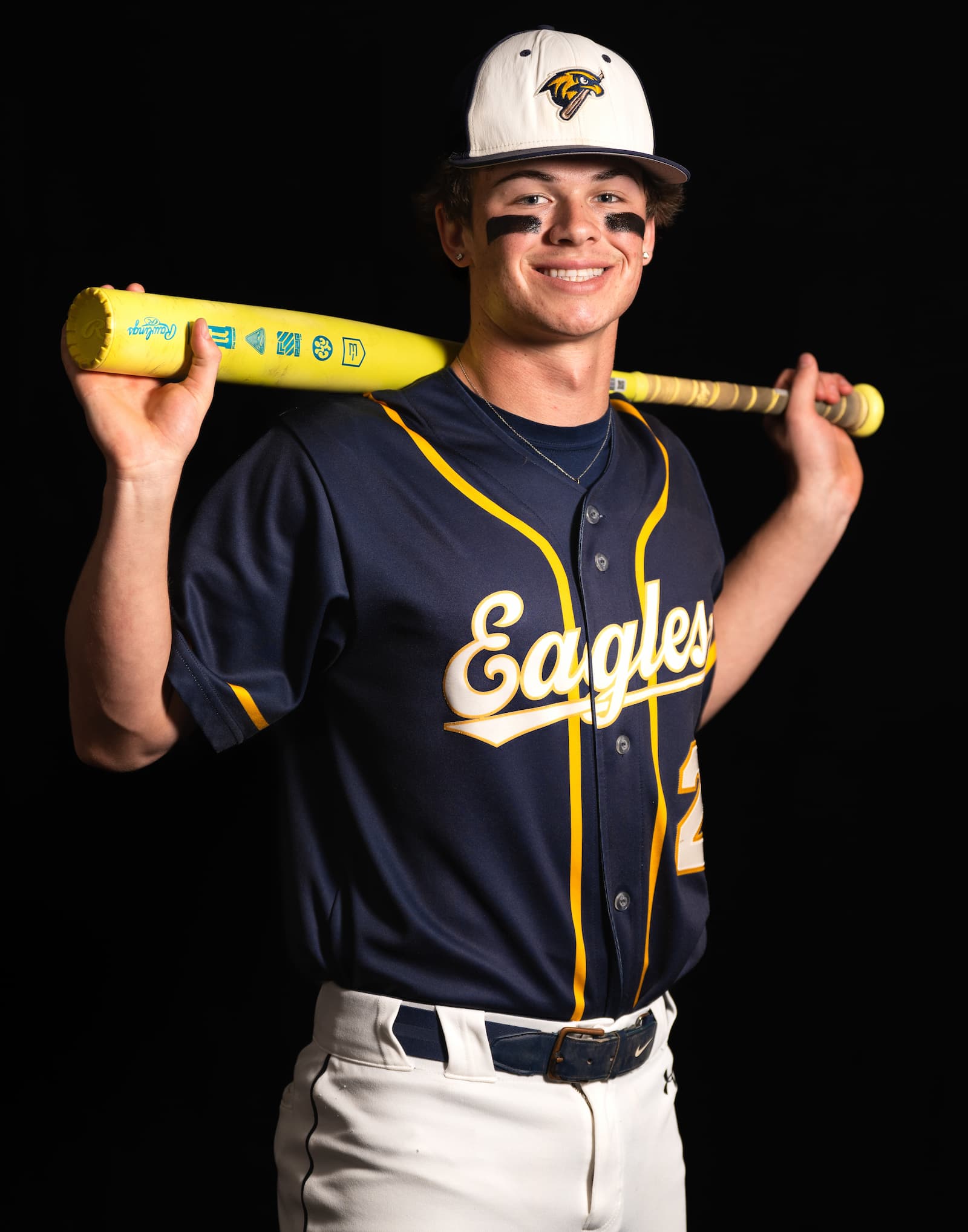 Eagles baseball athlete with yellow bat over shoulders