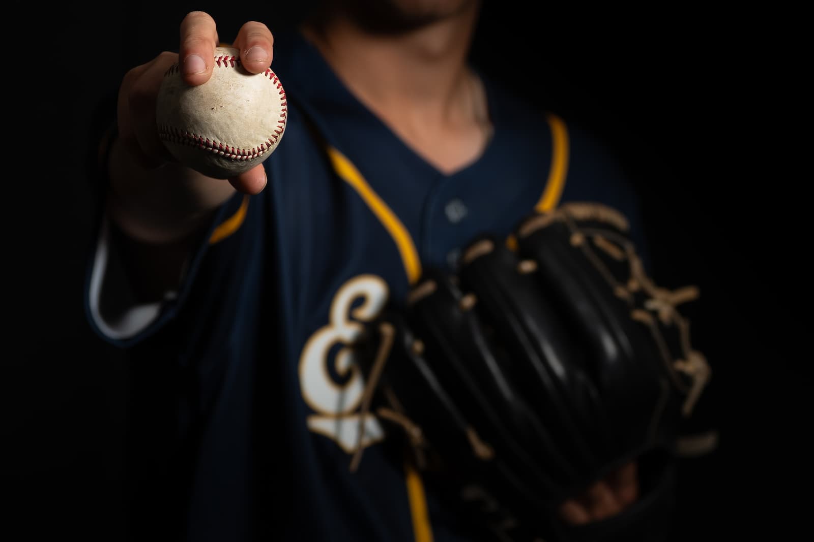Eagles pitcher holding baseball toward camera, glove in hand