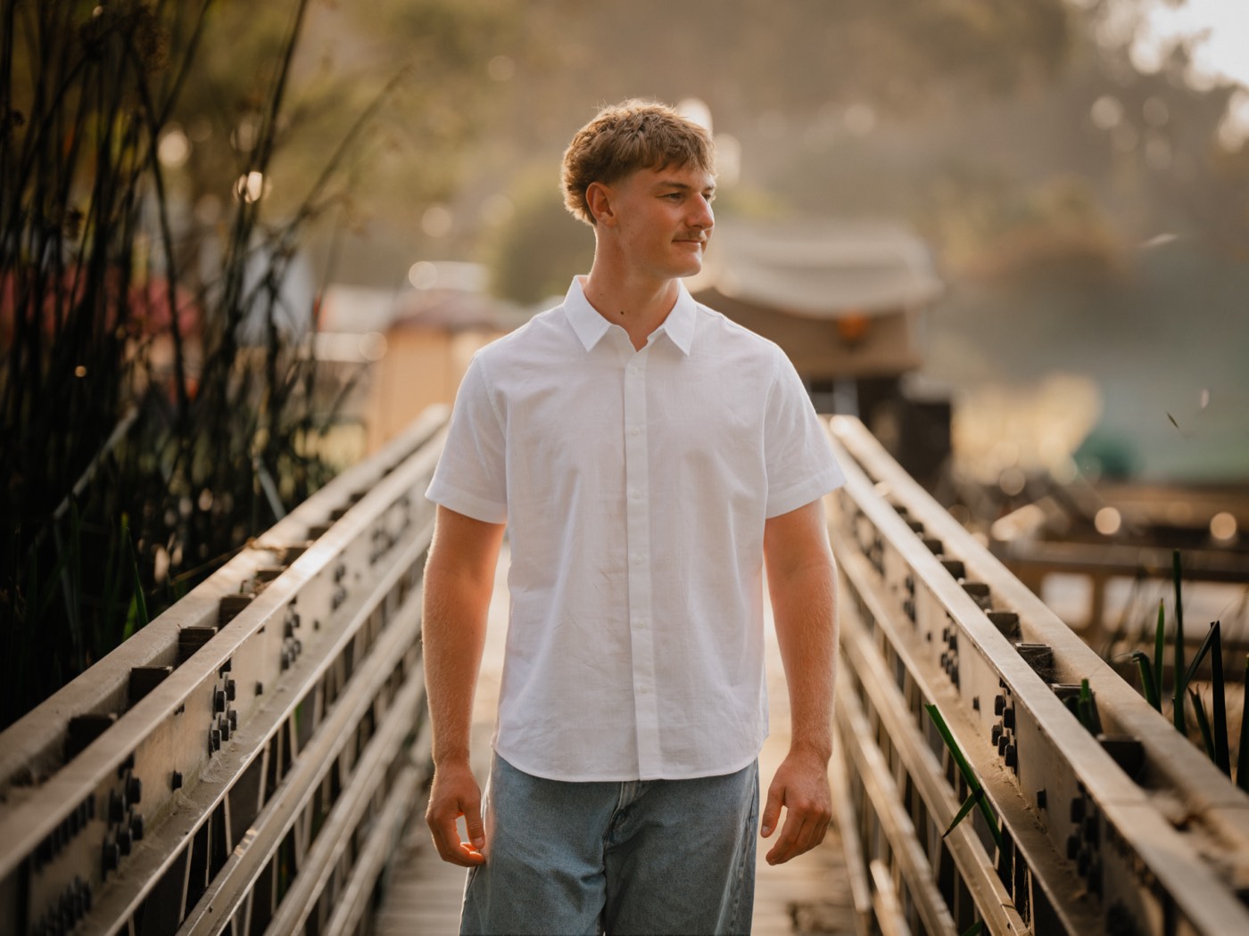 Senior portrait on a footbridge over the wetlands — Central Coast senior photographer