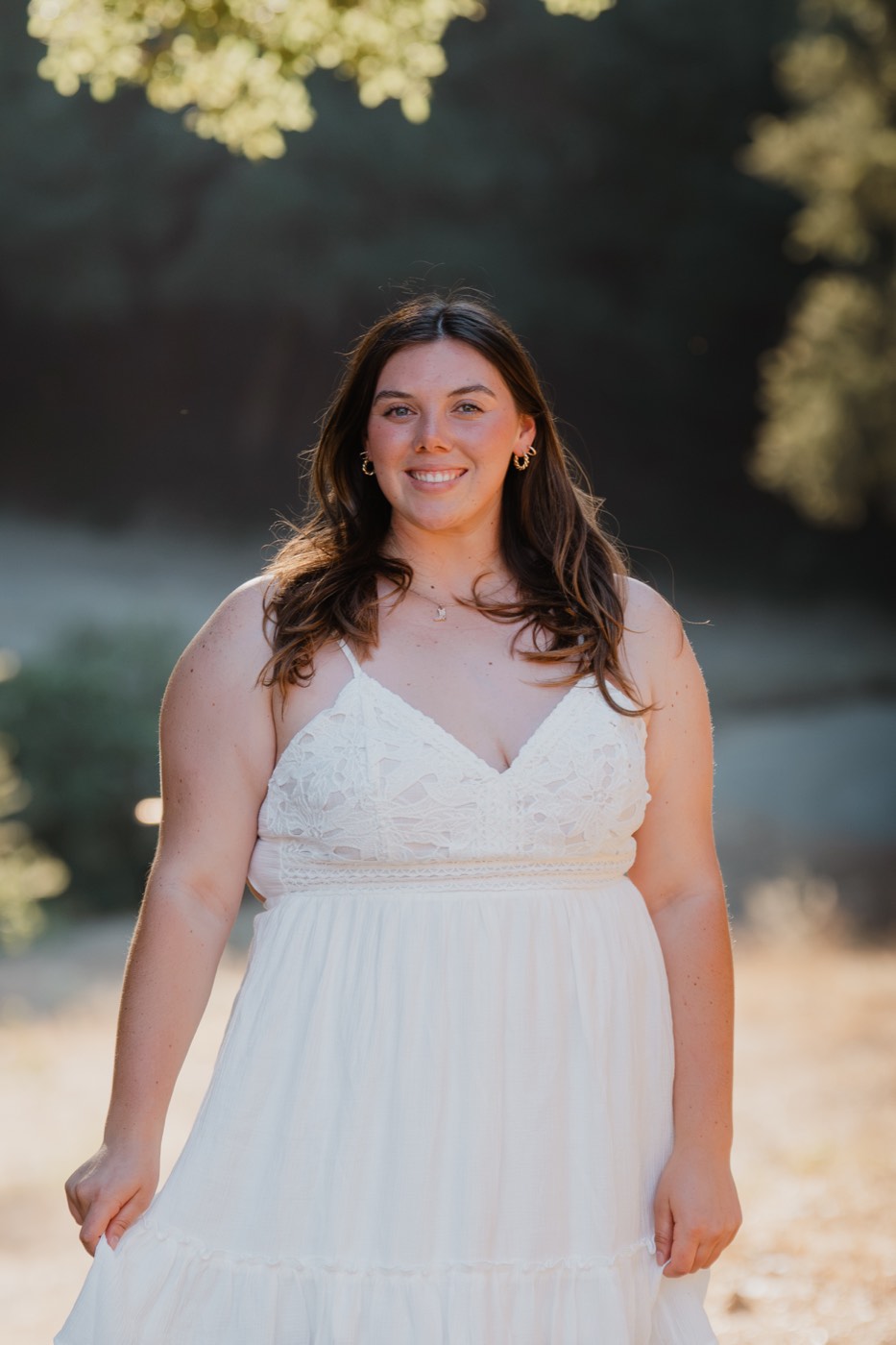 Senior portrait in a white lace dress, golden hour smile — Central Coast senior photographer