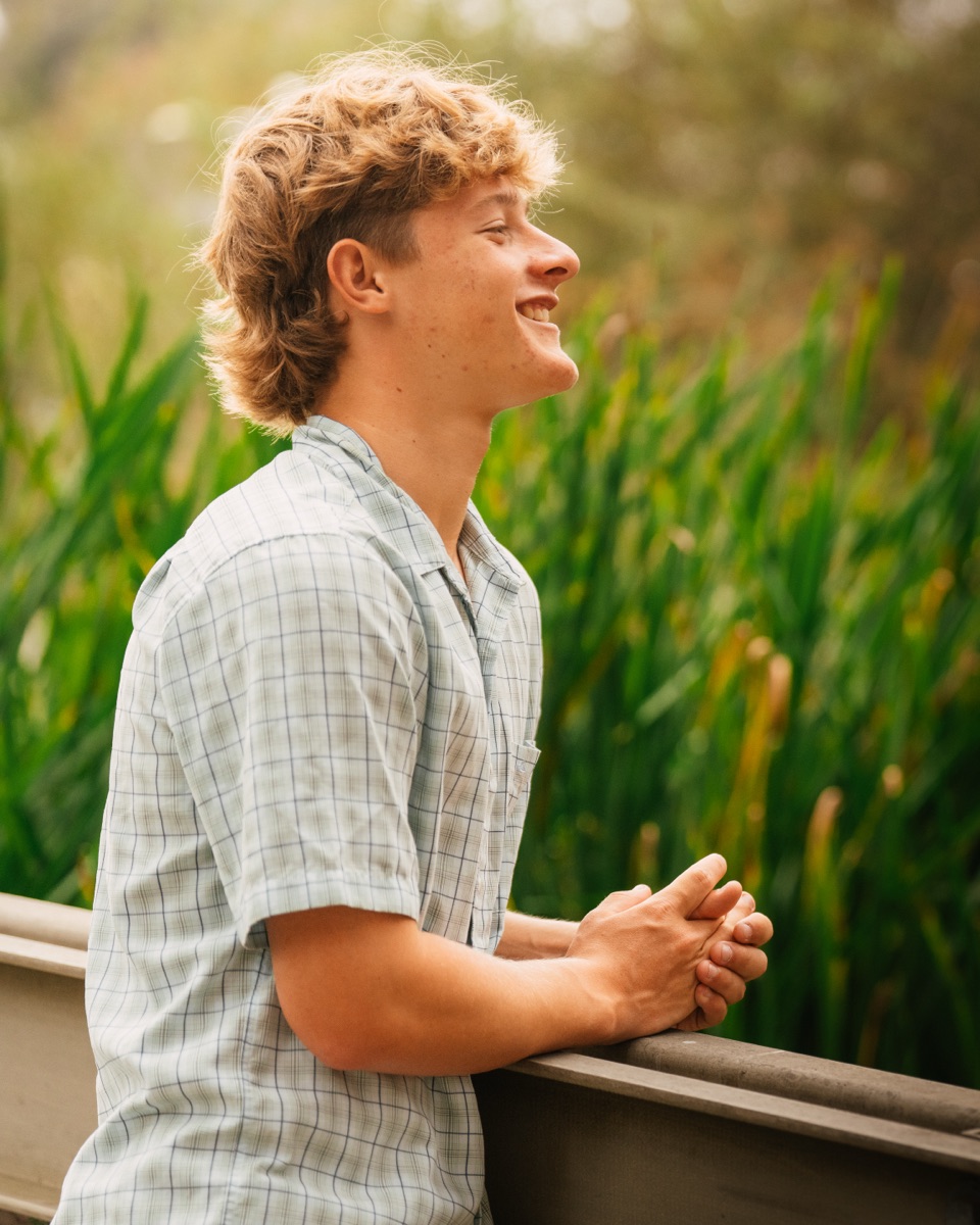 Senior boy candid profile portrait smiling by the reeds — Central Coast senior photographer