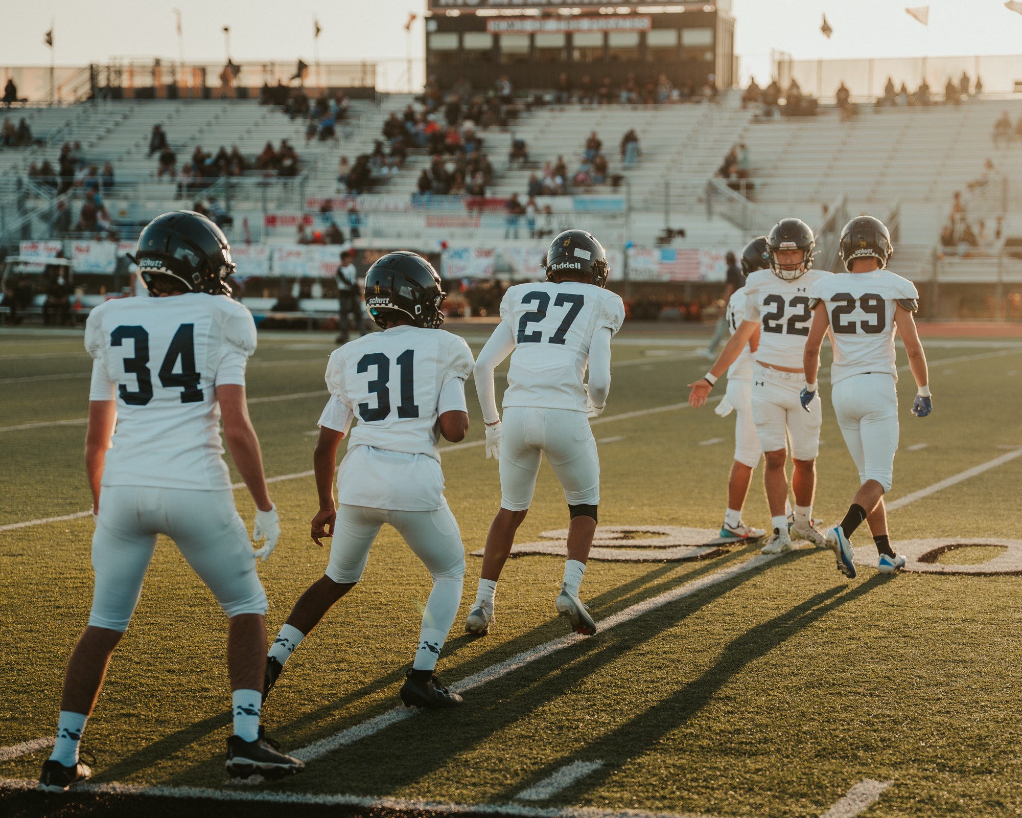 Arroyo Grande football players jogging onto the field at Rio Memorial Field, Santa Ynez